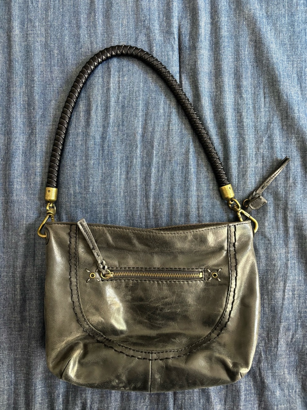 The Sak Boho Black Leather Shoulder Bag with Braided Strap and Bronze Hardware